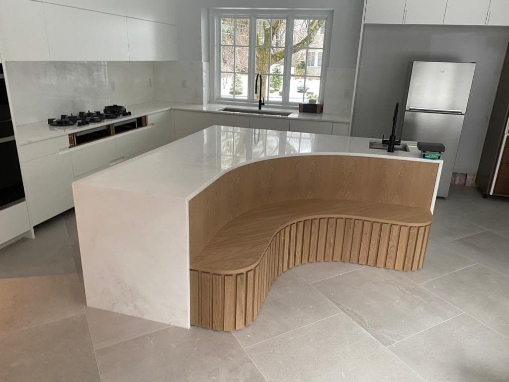Curved island with built-in oak banquette